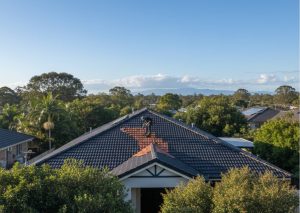 Licensed roofer repointing a roof under mild Brisbane winter sunlight, showcasing professional craftsmanship and preventive maintenance in dry conditions.